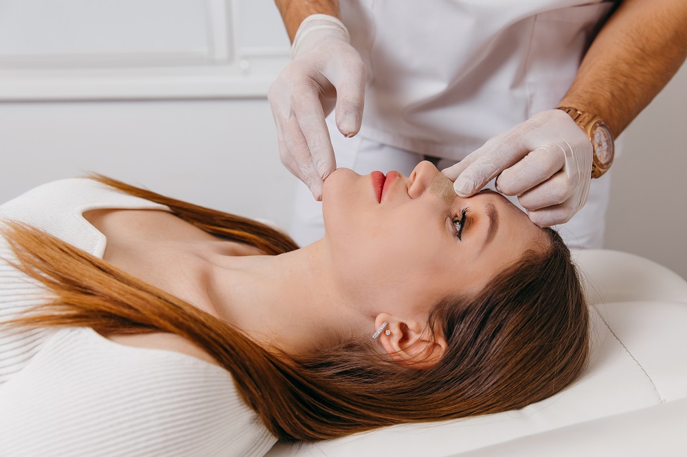 Mujer es examinada luego de rinoplastia.